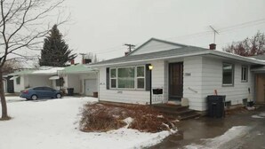 A single-story house with a front porch, a garage, and a driveway. - Self Check-In & Free Wi-Fi in this Fresh Remodel! (Idaho Falls)