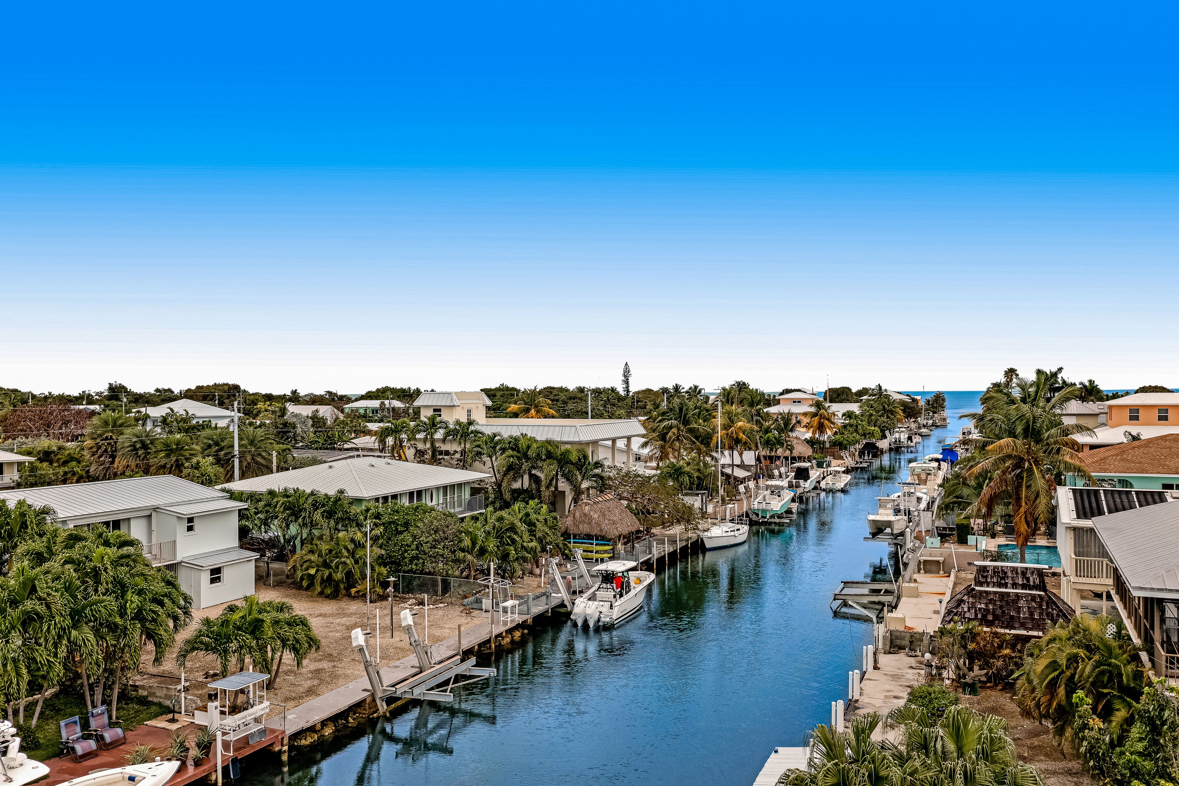 Canal-front home with boat access, deck, grill, & washer/dryer