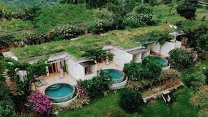 A residential property with a swimming pool, a patio area, and lush greenery. - Sumberkima Resort (Pemuteran)