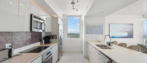A modern kitchen with a view to the outside, a built-in microwave, and a toaster.