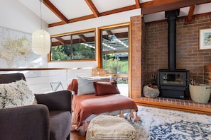 Relax in a spacious room with a large bed, a world map, and a cozy seating area.