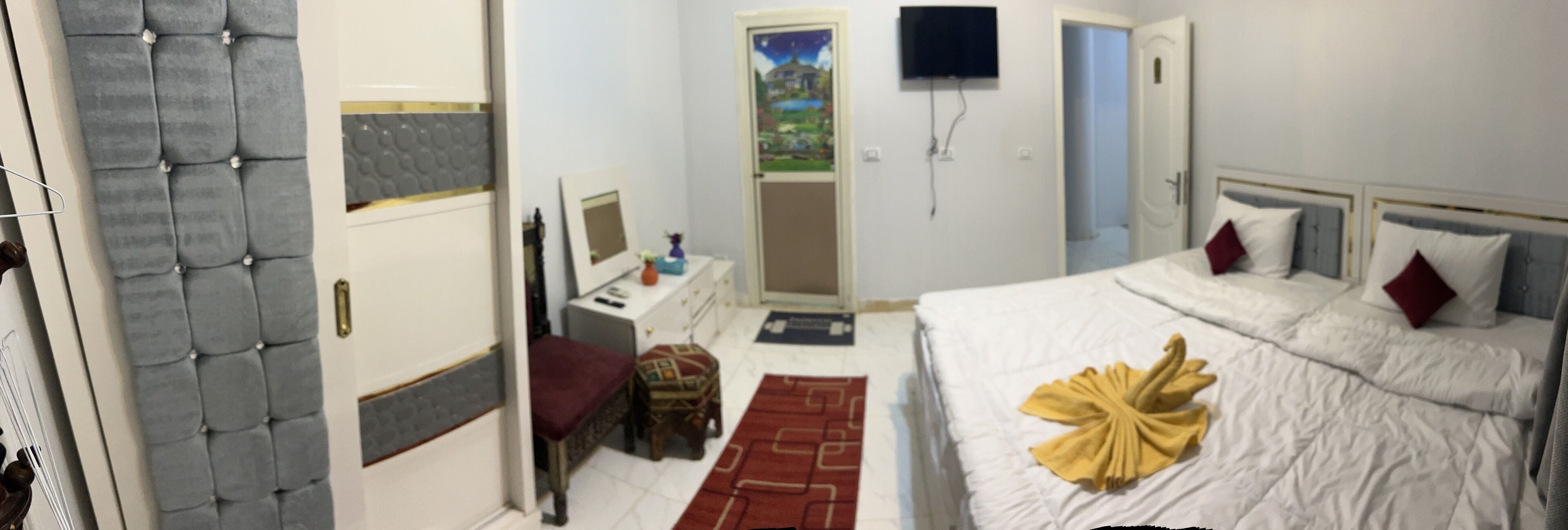 Une chambre d’hôtel équipée d’un lit, d’une télévision, d’un bureau et d’une chaise.