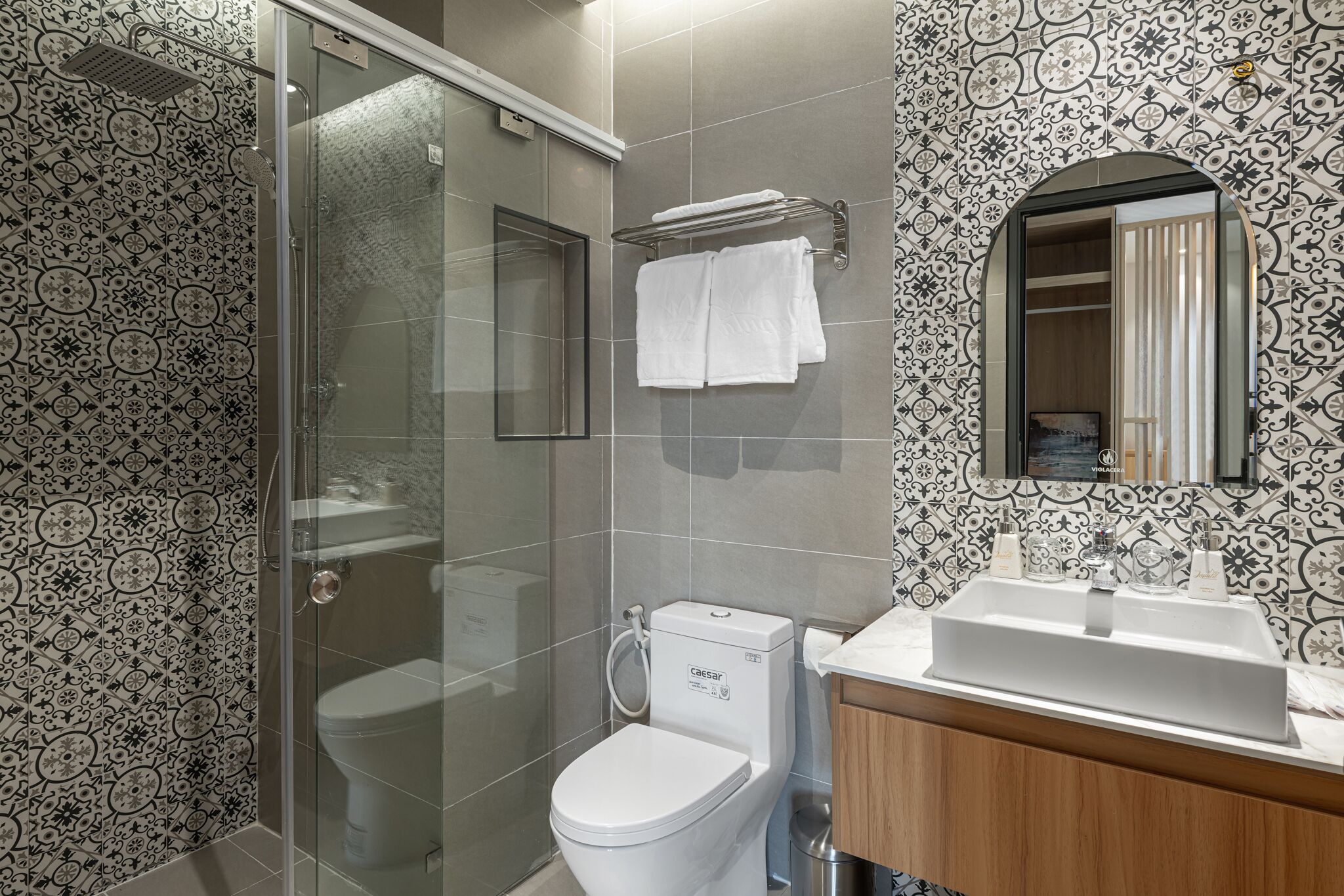 A bathroom with a shower, toilet, and sink.