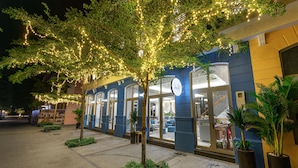 A building with a blue facade, large windows, and a tree with string lights. - Laputa Hotel Phu Quoc (Phu Quoc)