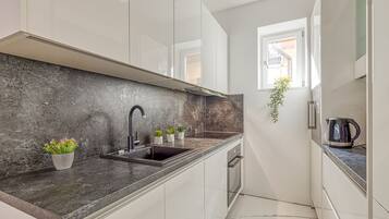 Family Apartment, 1 Bedroom (City Apartment Flow Ljubljana) | Private kitchen | Fridge, oven, stovetop, dishwasher