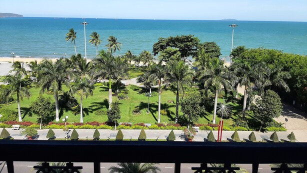 A coastal view with a promenade lined with palm trees and a beach in the background. - Anh Vy Hotel (Quy Nhon Nam)