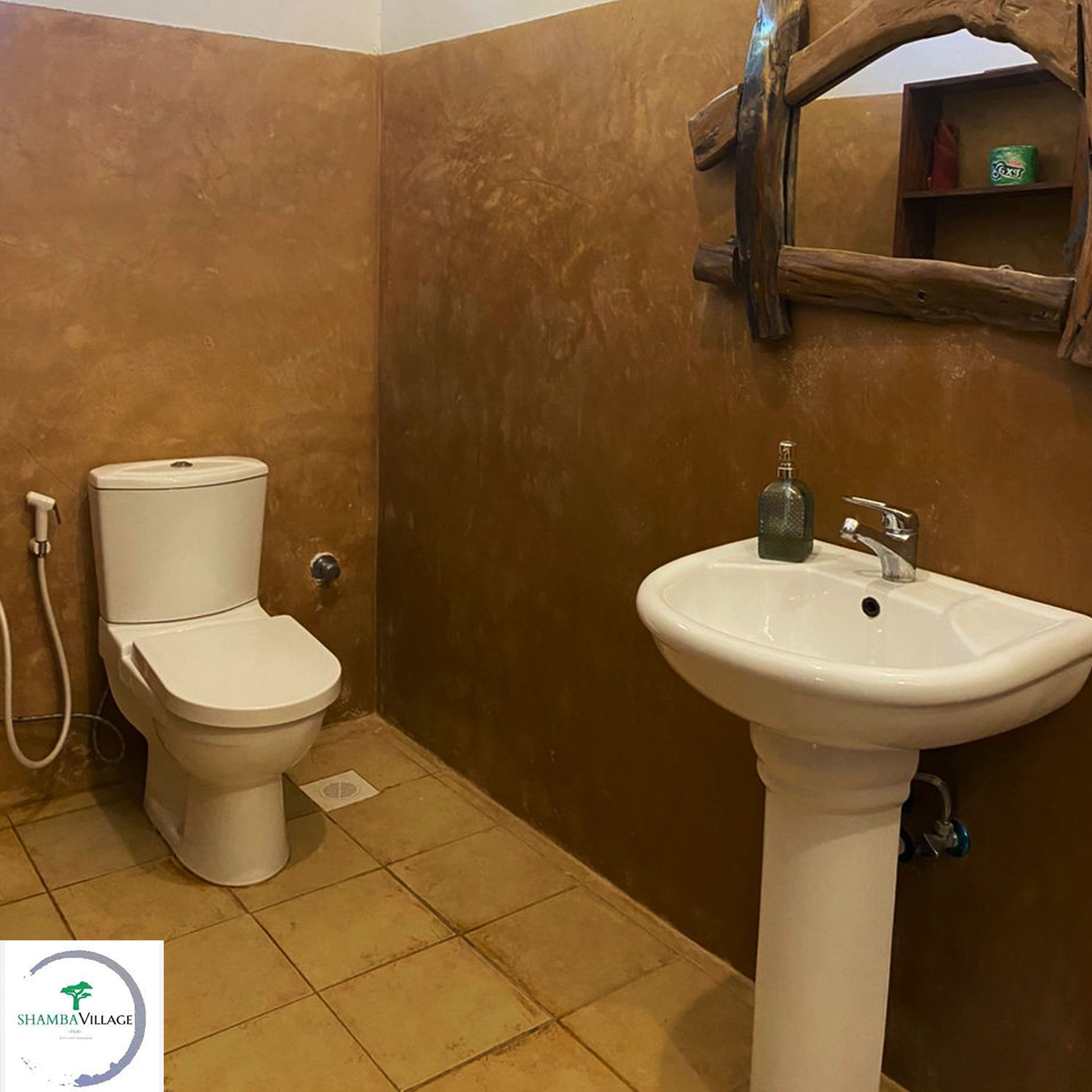 A bathroom with a toilet and a sink.