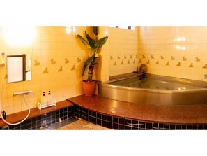 Bathroom features a bathtub, sink, and mirror.