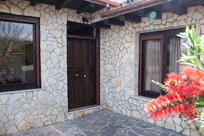 The building features a stone facade, dark doors, and a window.