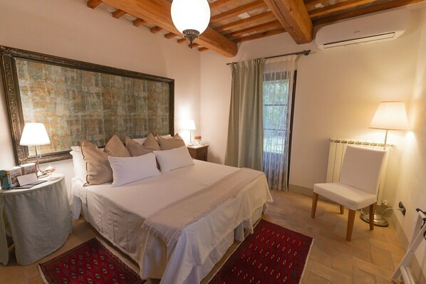 Cozy retreat with a large bed, bedside tables, and a spacious mirror.
