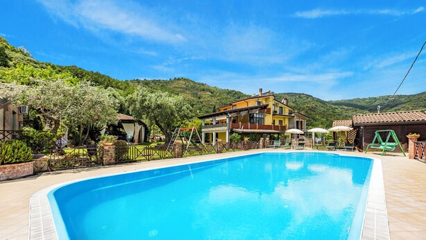 A swimming pool with a house in the background.