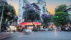 A street view with a Circle K convenience store, parked motorcycles, and a pedestrian crossing. -  Omina Hanoi Hotel and Restaurant  (Hanoi)