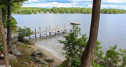 Winnipesaukee Waterfront Home sleeping 12 dock and sandy beach