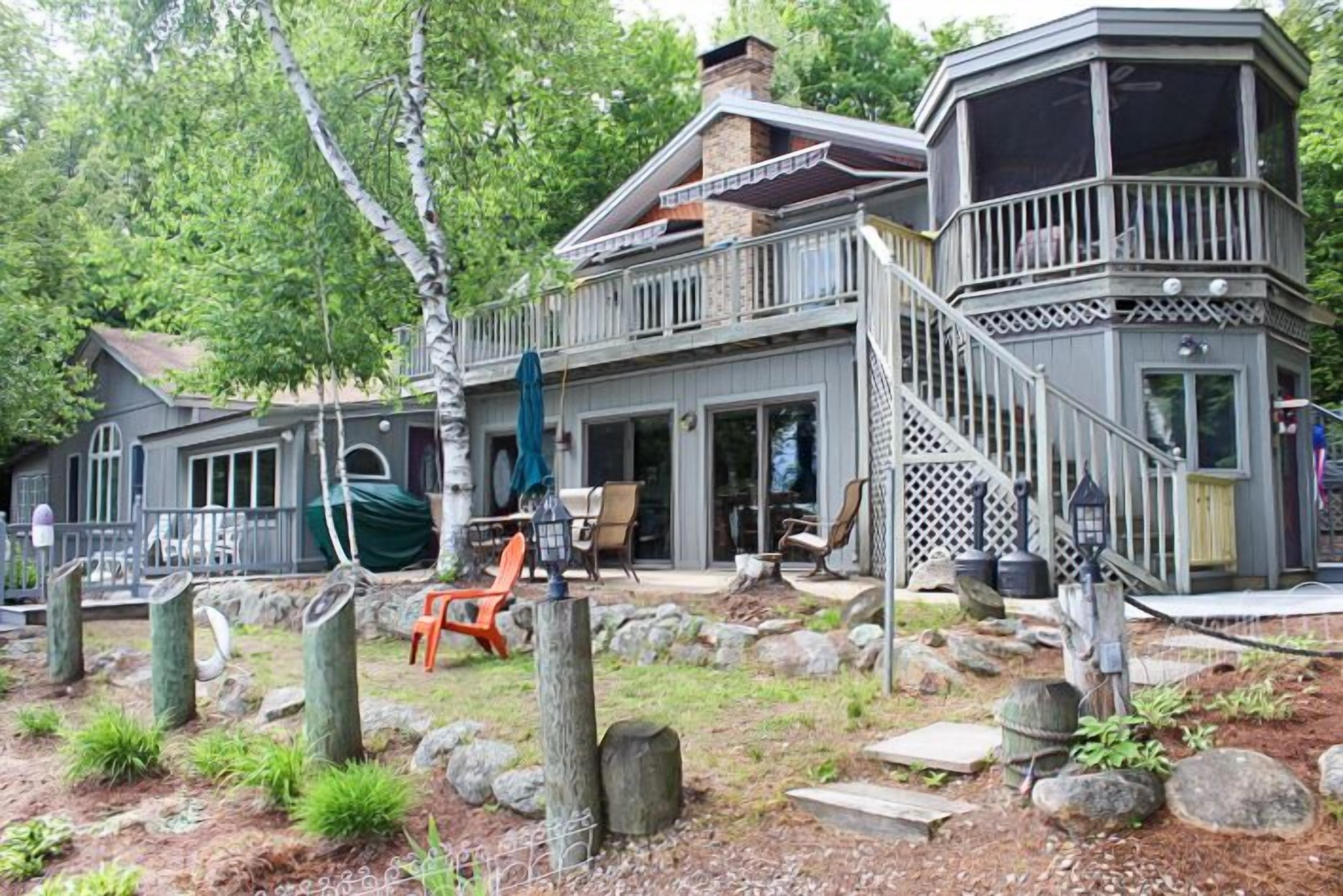 Winnipesaukee Waterfront Home sleeping 12 dock and sandy beach