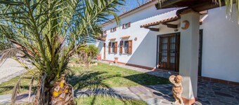 Detached cottage in a park-like garden overlooking the pool
