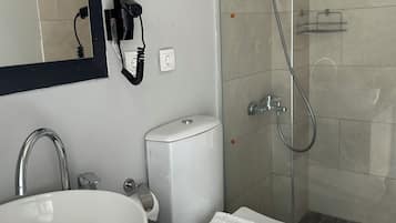 Shower, hair dryer, slippers, towels