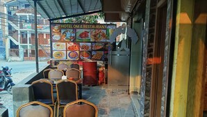 A restaurant with a menu board displaying various dishes. - Hotel om (Kathmandu)