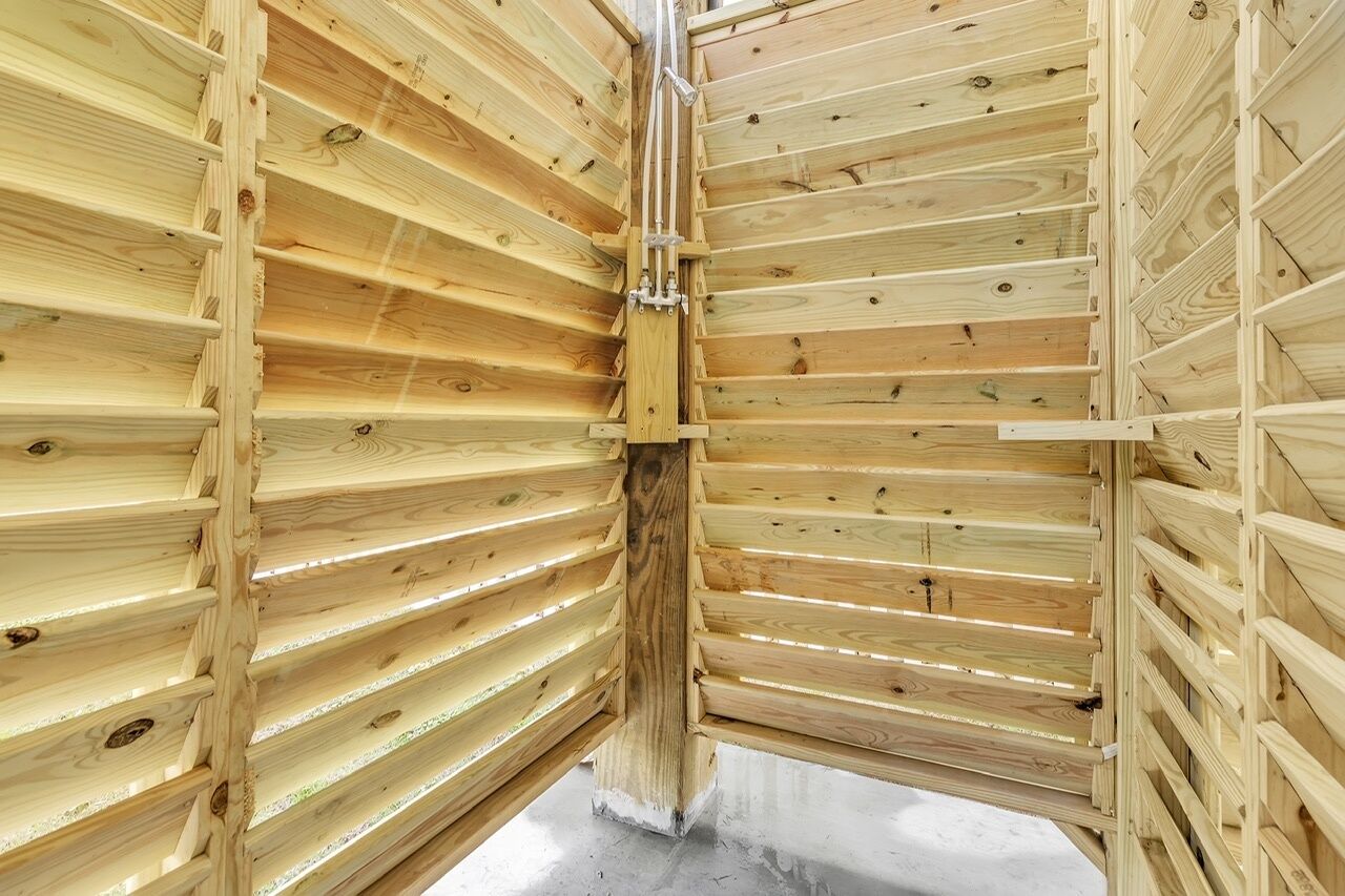 A wooden interior with slatted ceilings and a central support column.