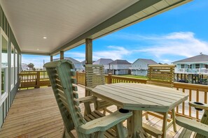 Enjoy outdoor dining or relaxation on this deck with a table and chairs.