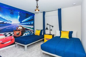 A bedroom with two beds, a race car mural, and a ceiling light fixture. - Last Minute Disney! Private Pool, Hot Tub, Game Room & Themed Bedrooms. Book Now! #30528 (Orlando)