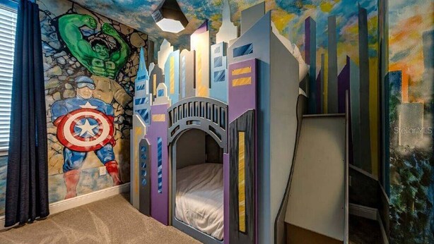 A child's bedroom with a mural of superheroes, a bunk bed, and a cityscape wall. - Last Minute Disney! Private Pool, Hot Tub, Game Room & Themed Bedrooms. Book Now! #47929 (Orlando)
