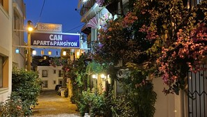 A cobblestone street leading to a boutique hotel with a sign reading "CAN APART & PANSIYON". - Can Butik Pansiyon (Çesme)