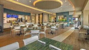 A spacious hotel lobby with multiple dining areas, a central reception desk, and a modern ceiling design. - Last Minute Disney! Private Pool, Hot Tub, Game Room & Themed Bedrooms. Book Now! #79591 (Orlando)