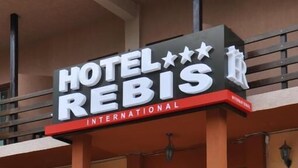 A hotel entrance with a sign reading "HOTEL REBIS INTERNATIONAL". - Hotel Rebis International (Chiscani)