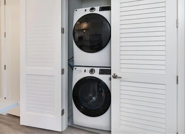 A laundry room with two stacked front-loading washing machines.