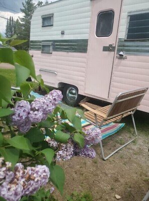 Park your home away from home in this cozy RV, complete with a sliding door and window.