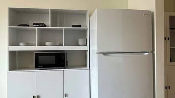 Fridge, microwave, coffee/tea maker, cookware/dishes/utensils
