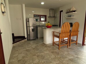 Fridge, coffee/tea maker, cookware/dishes/utensils, dining tables