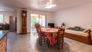 A compact living space with a dining area, kitchen, and a sofa. - Casa Brigitte by Interhome (Pinarellu)