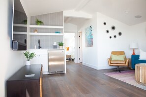 Enjoy a comfortable stay in this apartment with a spacious living area, dining table, and cozy seating area.