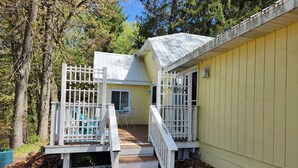 A yellow building with a white porch and a small table. - The "Frolic" (Pullman)