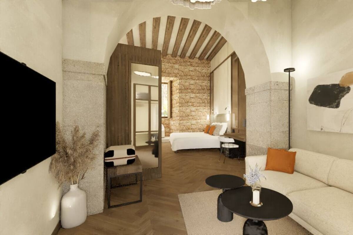 Een modern interieur met een stenen muur, een bank, een bijzettafeltje en een bed met uitzicht.