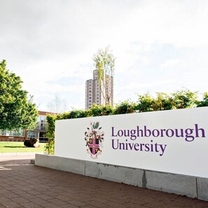 A sign for Loughborough University with a crest and the university's name.