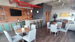 A modern interior with a bar area, seating, and a television.