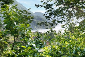 A mountainous landscape with a body of water, surrounded by greenery.