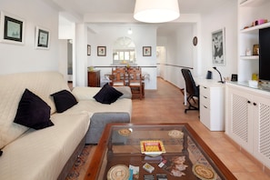 A living room with a sofa, coffee table, and a dining area with chairs and a table. - Apartment "Playa Rincón De La Victoria" with Sea View, Private Terrace & Wi-Fi (Rincón de la Victoria)