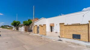 A street view with a row of buildings, a clear sky, and a sidewalk. - Villa "Tina" Close to the Beach and the City (torre lapillo)