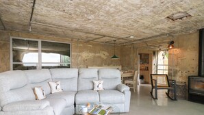 Ein modernes Wohnzimmer mit einem Ecksofa, einem Glastisch und einem Kamin.