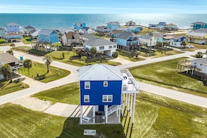 Stunning coastal homes with covered porches and decks, set amidst manicured lawns and scenic ocean views.