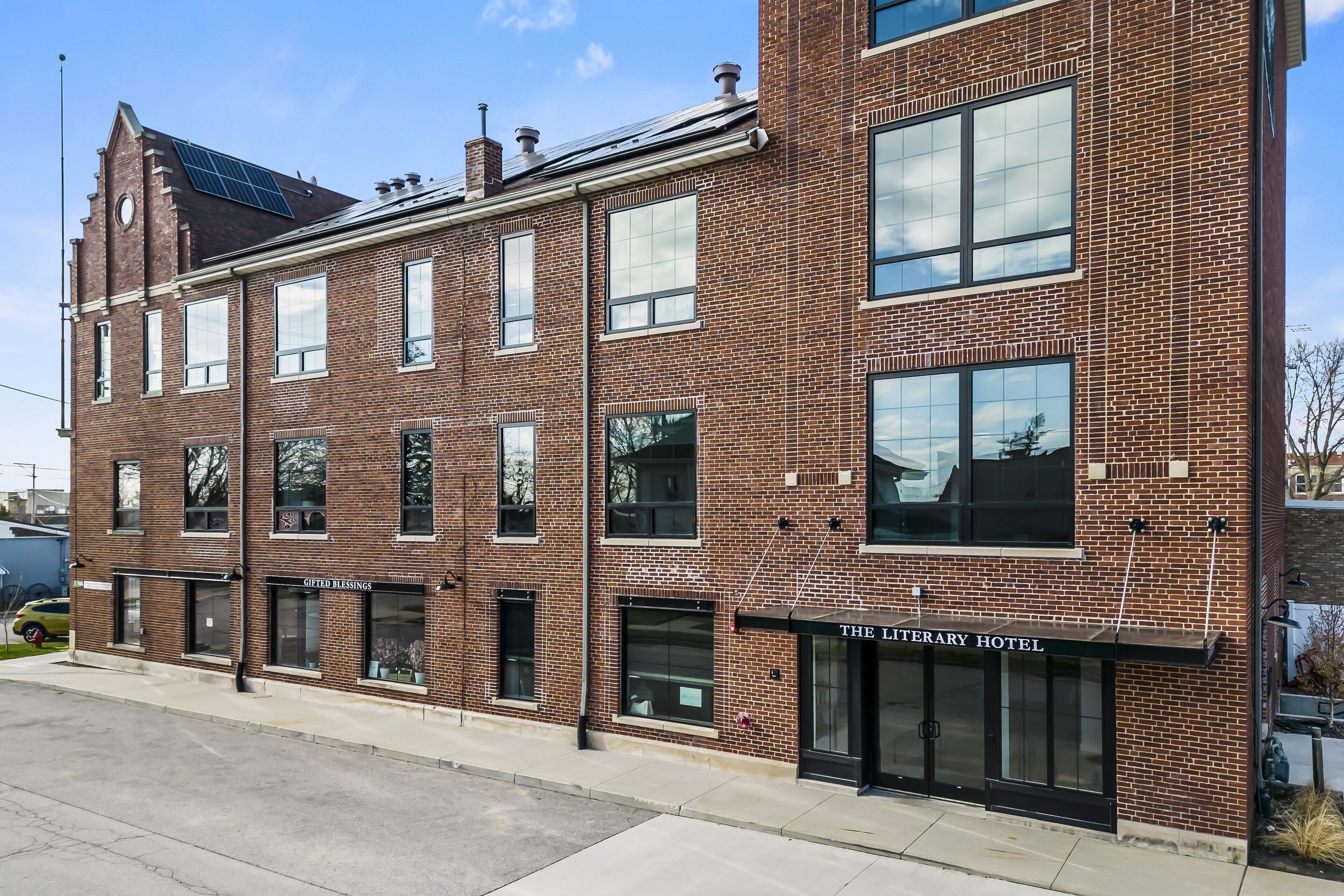 A brick building with a storefront labeled "The Literary Hotel."