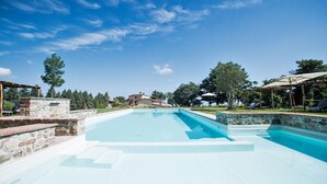 A swimming pool with stone steps and a pergola structure. - Luxury & Large Apt. in Siena Resort at Eagle (Trequanda)