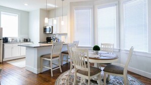 A modern kitchen with white cabinets, a central island, and pendant lighting. - HeartofHamilton Family Stay-Ham,Spooky Nook,Miami (Hamilton)