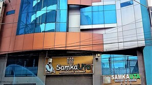 A multi-story building with a glass facade, a restaurant named "Samka Uta" at the ground level, and a hotel and suite named "Samka Uta" above it.