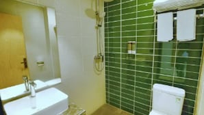 A bathroom with a sink, mirror, shower, and toilet. - Green Tree Inn Zhixuan Hotel (Nanning)