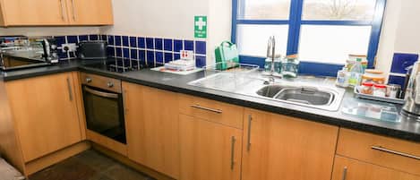 Fridge, electric kettle, toaster, cookware/dishes/utensils