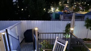 A wooden deck with two rocking chairs and a white fence. - Aviation Landing Vacation Homes Fallbrook CA (Fallbrook)